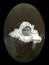 A baby is a pram around 1900.