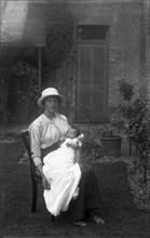 A lady in the garden with a baby.