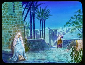 The only virgin, Mary sitting on a wall next to a donkey and Joseph.