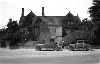 The Peacock hotel Rowsley with two cars parked in front from around 1925.