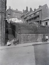 A street in Whitby, Yorkshire with four children.