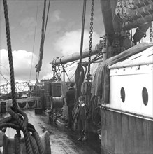 A boy and man on board a whaling ship.
