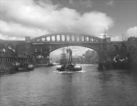 The steam paddle tugs on the River Wear with clipper ships in the background.