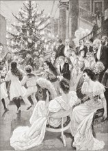 Children dancing in a circle round a Christmas tree.