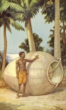 A native of Papua New Guinea with a fish trap.