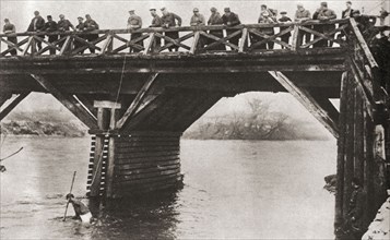 Bulgarian soldiers fishing for guns in the river at Nish.