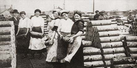 Women packing and loading shell castings during WWI.