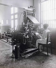 Woman working at a type-setting machine in the printworks of the Deli Courant in Medan.