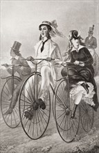 Two cyclists on Penny Farthing bicycles in the 19th century.