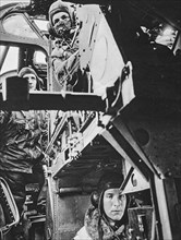 Inside a Halifax bomber, the pilot awaits the signal to take off, behind him is the second pilot and underneath the wireless operator.