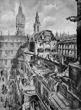 The ruined, bombed, House of Commons seen from the Palace of Westminster showing the gutted and roofless chamber.