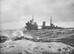 King George V war ship steaming full speed ahead in high seas.