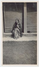 Seated woman in sari during railway outing