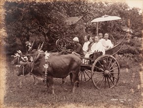 Women seated in a Burmese festival cart