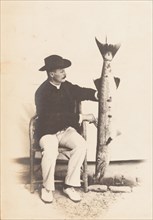 European man posing with a fish