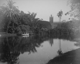 Scene showing rowing boat on a river and tropical gardens in Calcutta