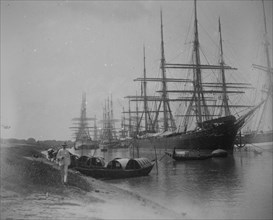 Sampans and sailing ships moored on a river inlet in Calcutta