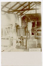 Two rubber factory workers with machine equipment