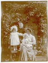 Children and two women in garden, Gikiyanakanda plantation
