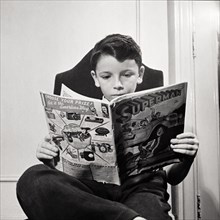 Boy Reading Superman Comic Book