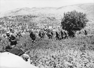 Arab Army of Liberation soldiers march across fields near Castel, east of Jerusalem.