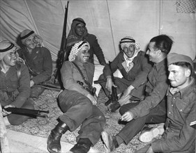 Arab soldiers relax in their tent with the arms nearby, near Nablus, Palestine.