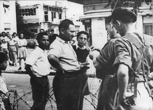 British soldiers checking the identification papers of Jewish people in Tel-Aviv