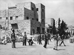 A Jewish patrol in the Katamon district of Jerusalem, on the left the ruins of the Semiramis hotel, destroyed by a Haganah bomb.