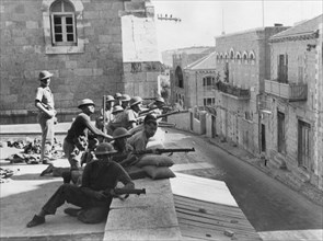 British troops on the roof of the French Hospital in Jerusalem, fighting against Arab rebels.