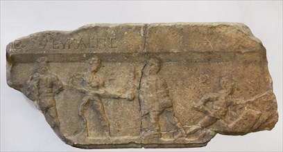 Gladiator fight. Greek inscription: ""Leukaspis"" (name of the gladiator). Fragment of a marble