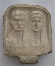 Bust of a bearded man and a woman. Inscription in Greek. Stele of Ziles, son of Pyroulas, erected