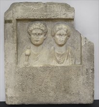 Funerary stele bearing busts of a man with a sword and a woman. Late 1st century AD - early 2nd