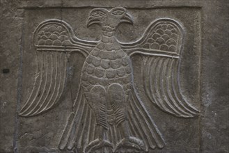 Double-headed eagle in heraldic attitude. Relief on a facing slab. Red schist. 11th-12th centuries