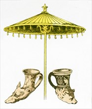 The illustration here shows ancient Greek artifacts. They are two rhytons and one parasol.The