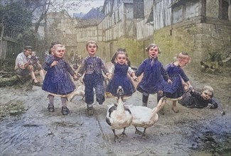 Children playing with geese on the village street, running in a row after the animals.