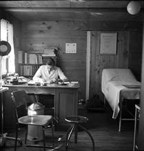 Physician in his surgery, in the 40s