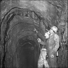 Geologists analysing shaft, Oil deposit; 1964.