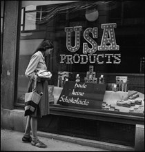 Woman looking at goods on display, around 1944.