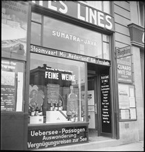 Shop window of Kuoni travel agency, advertising wine; 1944.