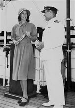 Greta Garbo on board of the 'Gripsholm' with captain, on her way to Sweden; ca. 1946.