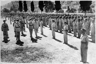 King Paul inspects ex-guerillas on island Makronissos.