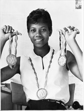 Olympic Games Rome 1960: Wilma Rudolph showing her 3 gold medals .