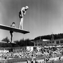 Bathing people on the diving platform in the outdoor-swimmingpool Dolder.