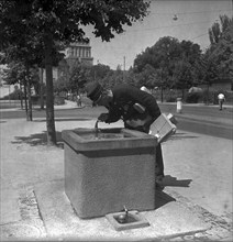 Postman drinking water, Zurich 1947