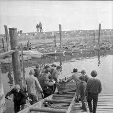 Boys launching a boat, Rorschach harbour 1958