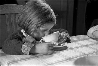 Girl drinking milk, around 1960