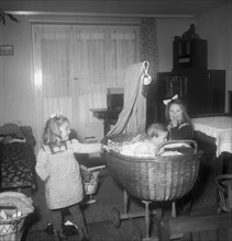 Girls with little sister in bassinet, Rekingen AG 1950