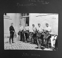 Horse inspection, cleaning the saddles. ca. 1918