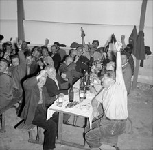 Topping-out ceremony of the SAFFA fair 1958: workers celebrating.