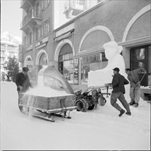 Davos; men clearing snow; 1951.